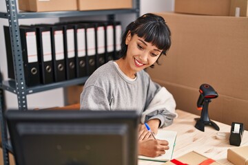 Sticker - Young woman ecommerce business worker writing on book working at office