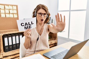 Wall Mural - Middle age brunette woman wearing operator headset holding call me banner doing stop gesture with hands palms, angry and frustration expression