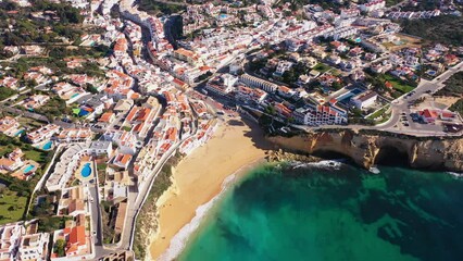 Wall Mural - Beautiful aerial views of the seaside tourist town of Carvoeiro with cliff beaches and traditional Portuguese houses.