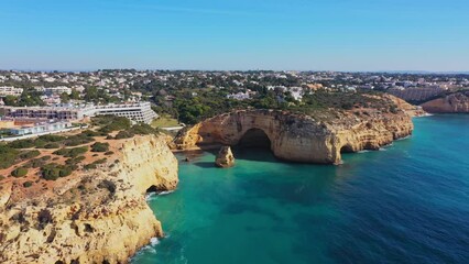 Wall Mural - Beautiful aerial views of the seaside tourist town of Carvoeiro with cliff beaches and traditional Portuguese houses.