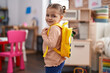 © Krakenimages.com - Adorable hispanic girl student smiling confident wearing backpack at kindergarten