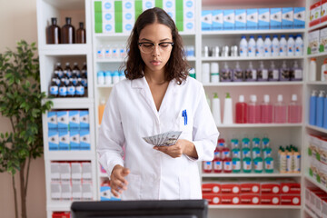 Sticker - Young african american woman pharmacist counting dollars at pharmacy