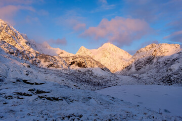 Wall Mural - north. winter landscape during sunset. bright sky. mountain peaks during sunset. snowy winter. natur