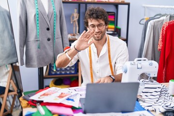 Sticker - Young hispanic man tailor smiling confident having video call at clothing factory