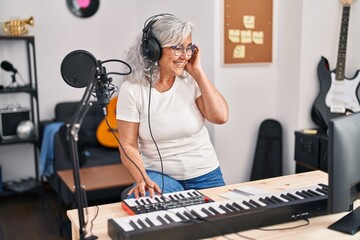 Sticker - Middle age woman musician playing keyboard piano at music studio