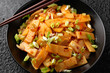 © grinchh - Spicy bamboo shoot salad in black bowl. Asian food
