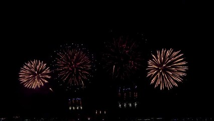 Wall Mural - Amazing beautiful colorful firework display over sea on celebration night. Fireworks show for happy new year, 4k footage.