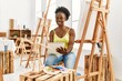 © Krakenimages.com - Young african american artist woman drawing manikin on notebook at art studio.