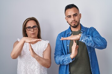 Poster - Hispanic mother and son standing together doing time out gesture with hands, frustrated and serious face