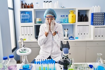 Poster - Brunette woman working at scientist laboratory rubbing eyes for fatigue and headache, sleepy and tired expression. vision problem