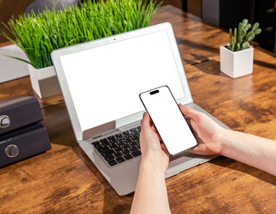 Poster - Laptop and smartphone mockups. Hand holding mobile phone mock up for app ad and PC display on office desk for web site ads