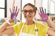 © Krakenimages.com - Adorable girl smiling confident showing painted palm hands at art studio
