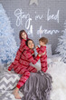 © Olena - People in same family look red pajamas playing at home in christmas day. Happy funny kids daughter, son with mother spend time, enjoying being together in decorated winter bedroom. New Year holidays