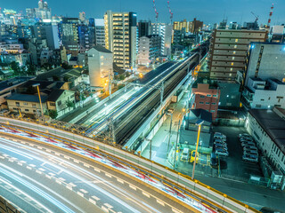 Wall Mural - Japan architecture. Osaka city roads. Trestle over railroad. Evening panorama of city of Osaka. Asian city from birds eye view. Tourism in Japan. Road architecture in Japan. Tour to Osaka