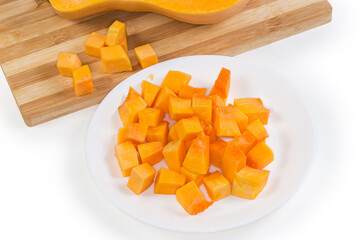 Wall Mural - Diced slices of butternut squash on dish against same squash