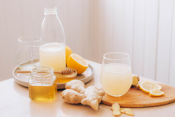 Wall Mural - Glass with drink from fresh ginger root, ingredients for its preparation honey lemon kitchen table