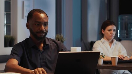 Poster - Portrait of african american confident man working on laptop to plan company report and executive presentation online. Analyzing business data and software to create network app in office.
