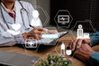 Healthcare and medically concept, Doctor and patient are discussing something with medicare icon on virtual screen,Medical physician working in hospital writing a prescription.