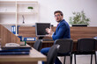 © Elnur - Young male employee working in the office