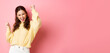 © Mix and Match Studio - Cheerful happy woman achieve goal, celebrates success, saying yes and dancing, do victory champion dance, standing against pink background