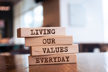 Wall Mural - Wooden blocks with words 'LIVING OUR VALUES EVERYDAY'.