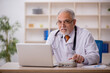 © Elnur - Old male doctor in telemedicine concept