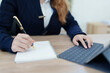 © Jirapong - Portrait of a young Asian man showing a smiling face as she uses his notebook, tablet computer and financial documents on her desk in the early morning hours