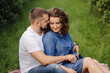 © andriyyavor - young couple sitting on grass and relaxing