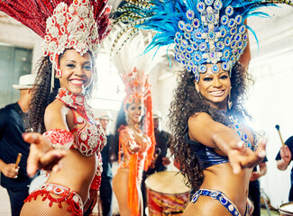 Portrait of women, samba and carnival band in Brazil for celebration, mardi gras and party. Salsa dancers, happy group and music festival performance in rio de janeiro for culture, concert and show