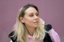 Woman In A Pink Hoodie And Fake Fur