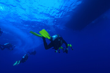  Divers waiting at the safety stop. Underwater bubbles, water bubbles. Safety stop while diving. Red Sea, Egypt.