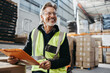 © Jacob Lund - Cheerful senior man working in a distribution warehouse