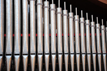 Church Pipes Attached To An Organ Indoors.