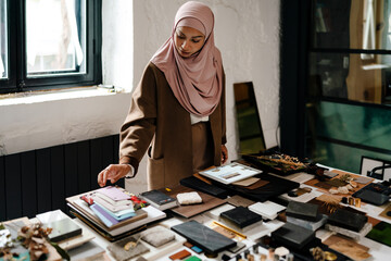 Wall Mural - Female muslim architect working on tablet at workshop