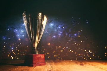 Wall Mural - image of gold trophy with sparkly overlay over dark background