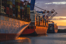 Germany, Hamburg, Container Ships In Port Of Hamburg At Dusk