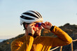 © Westend61 - Cyclist wearing helmet and goggles standing on sunny day