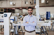 © Westend61 - Confident engineer with arms crossed standing in industry