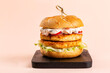 Fish sandwich or fish burger made with breaded, fried perch, bread bun, iceberg salad, vegetables and tartare sauce, made of mayonnaise, capers, red pepper, lemon juice.