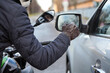 Motorcyclist knocking on the car window with a glove, close-up