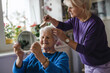 © pikselstock - Woman combing hair of elderly mother