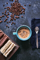 Wall Mural - cup of coffee with roasted coffee beans and chocolate background