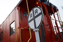 Railroad Sign And Red Caboose Taken Late In The Day
