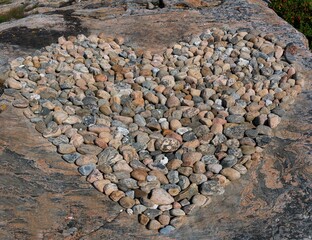 Poster - Closeup shot of a pile of brown gray rocks in the shape of a heart