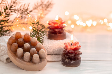 Wall Mural - Christmas spa composition with incense sticks and soap on a blurred background.