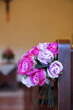 The church benches are decorated with a nice arrangement of roses.