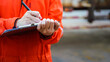 © Nattawit - A safety officer is writing on the checklsit document during safety audit workplace at the factory. Industrial expertise occupation working scene. Selective focus at hand's part.
