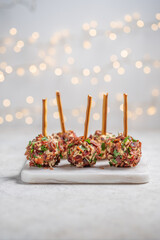 Christmas cheese ball appetizers with bacon, pecans and herbs.