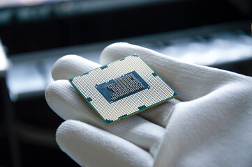 Poster - an image of a technician holding a cpu in his hand.