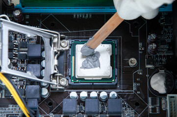 Wall Mural - Top view Technician applying silicone Cooling on CPU chips